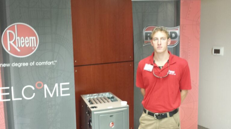 economy team member standing next to rheem unit